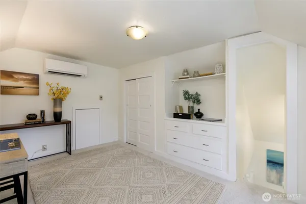 a room with a dresser and a window