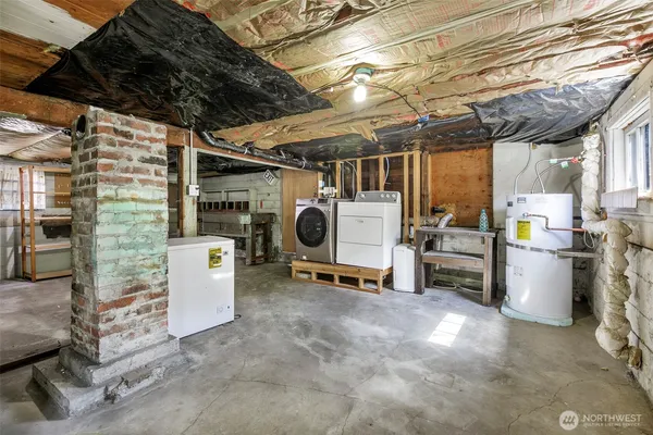 a view of backyard with large trees and wooden fence