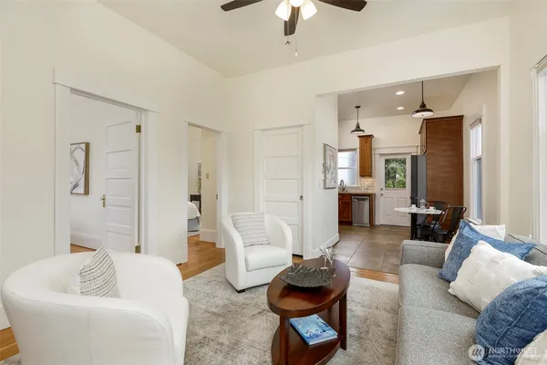 a living room with furniture and a chandelier