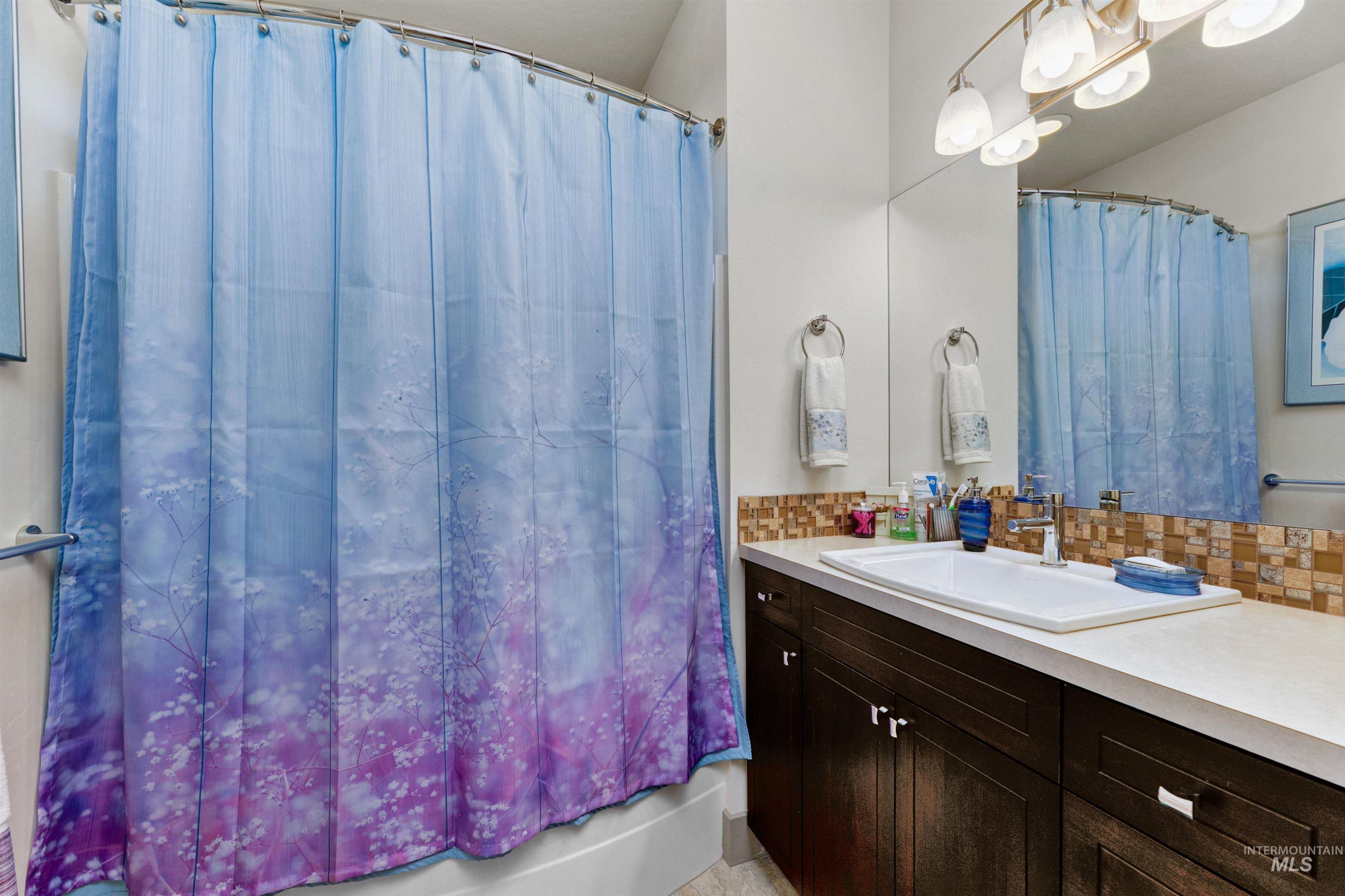 24398 Tombstone Ridge Court Middleton, ID 83644 - Photo 10 of 47 Bathroom featuring a dark wood vanity with white countertop, an integrated rectangular sink, and a full-width mirror