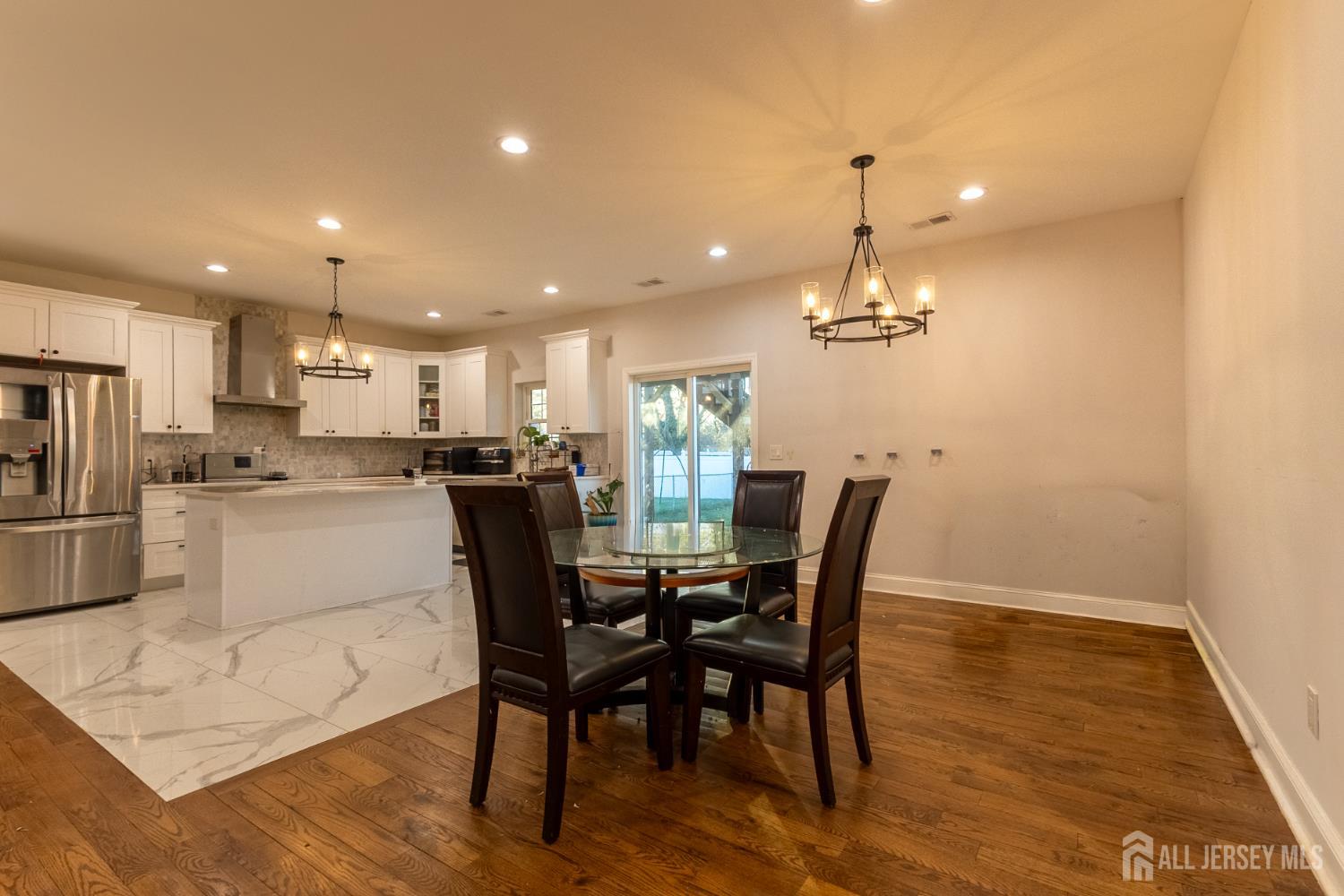 55 Walnut Street Edison, NJ 08817 - Photo 15 of 29 a kitchen with stainless steel appliances kitchen island granite countertop a dining table chairs and granite counter tops