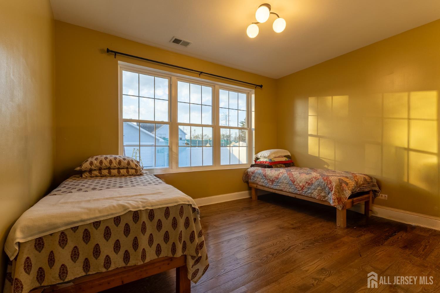 55 Walnut Street Edison, NJ 08817 - Photo 16 of 29 a bedroom with a bed and wooden floor