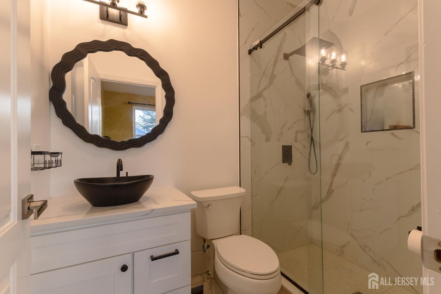 55 Walnut Street Edison, NJ 08817 - Photo 17 of 29 a bathroom with a sink a toilet and a mirror