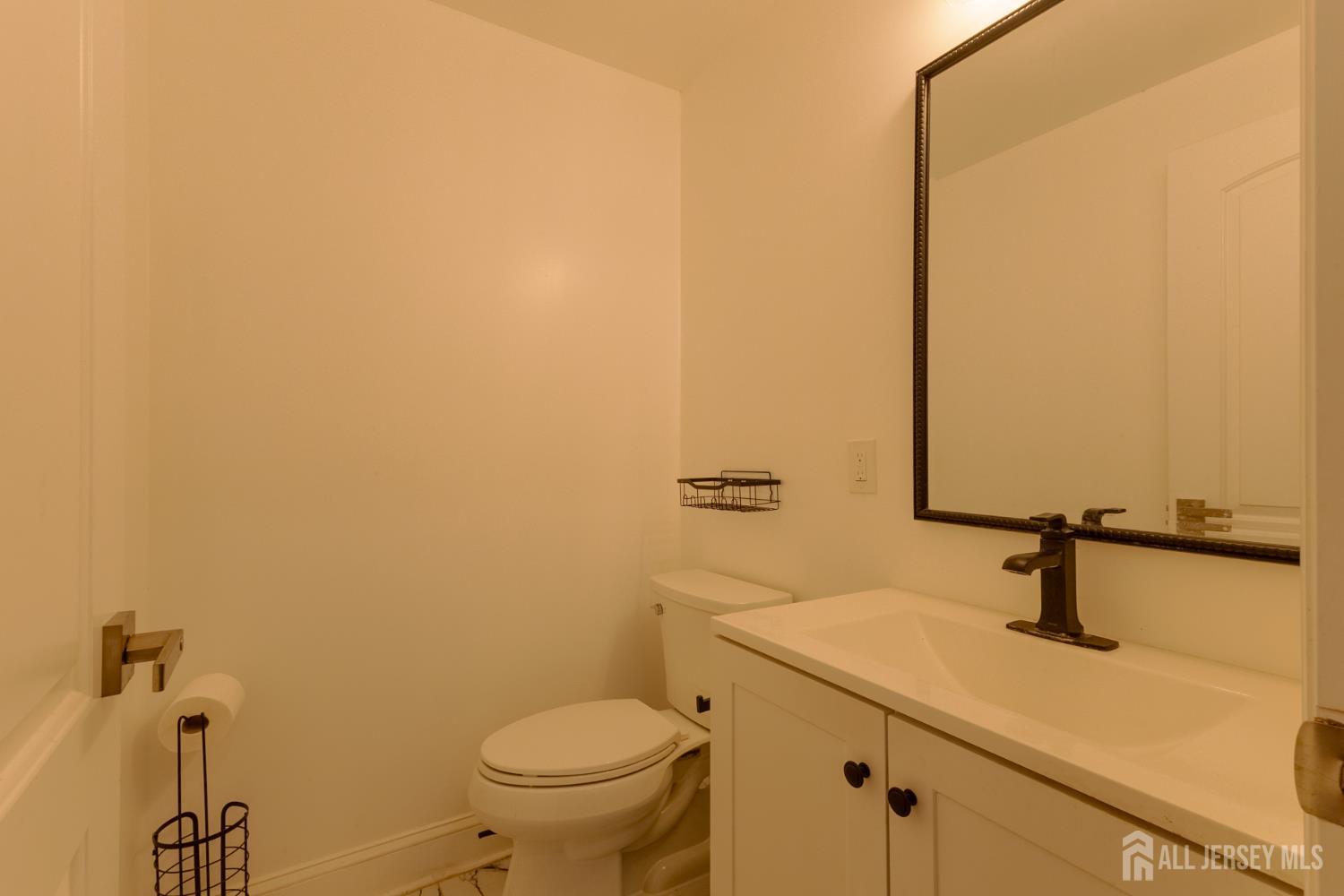 55 Walnut Street Edison, NJ 08817 - Photo 19 of 29 a bathroom with a sink a toilet and mirror