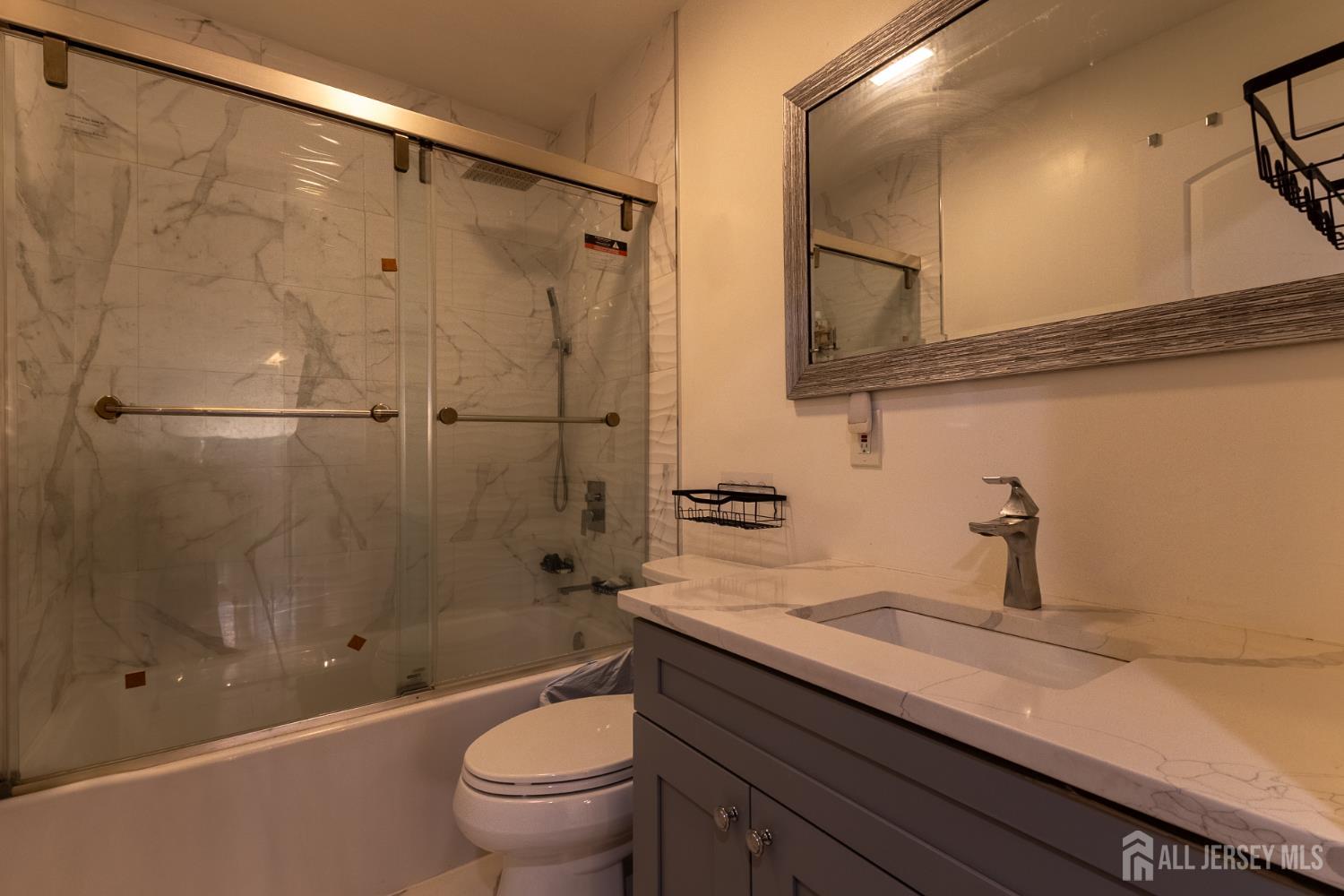 55 Walnut Street Edison, NJ 08817 - Photo 26 of 29 a bathroom with a granite countertop sink a toilet and shower