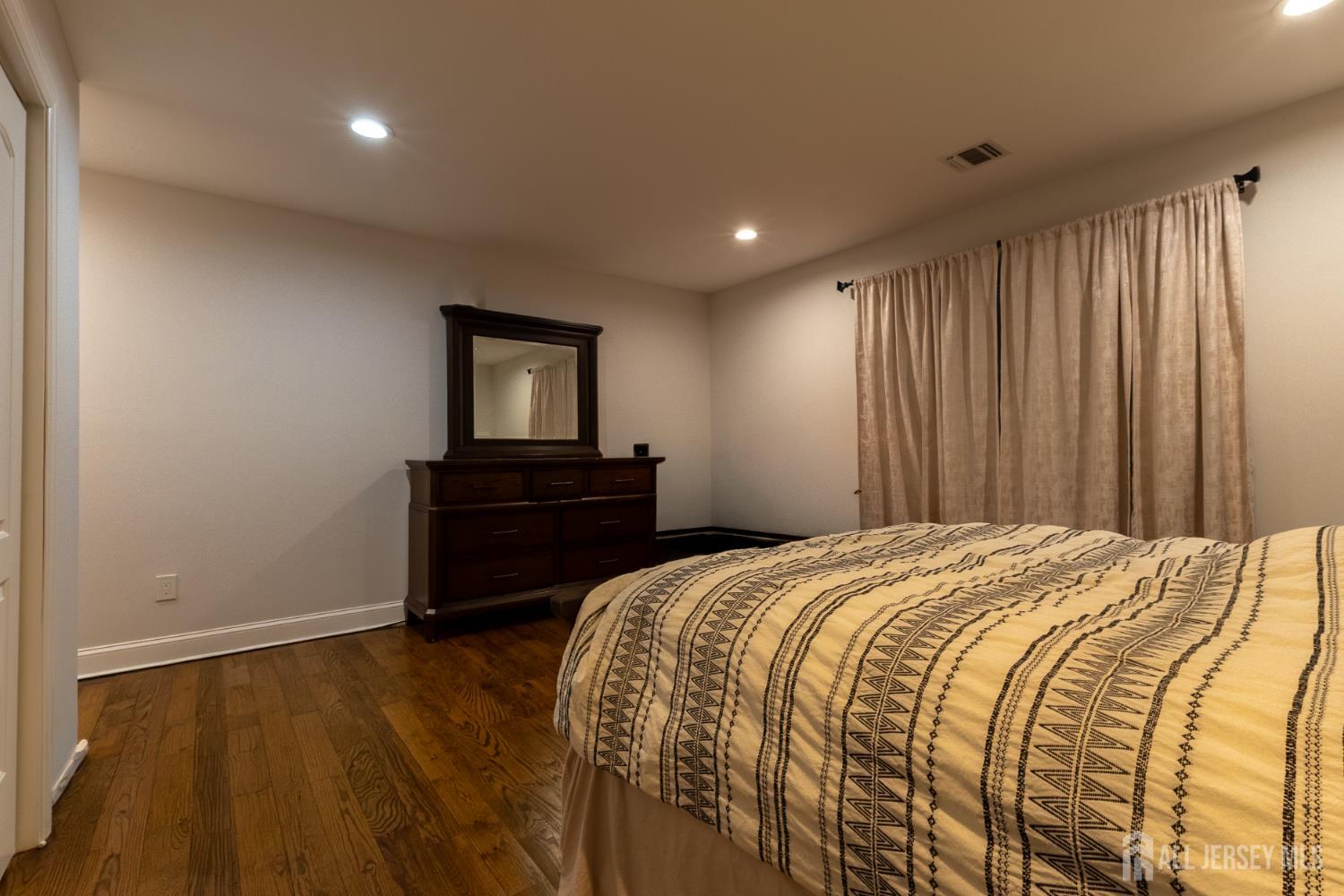 55 Walnut Street Edison, NJ 08817 - Photo 27 of 29 a bedroom with a bed and a tv