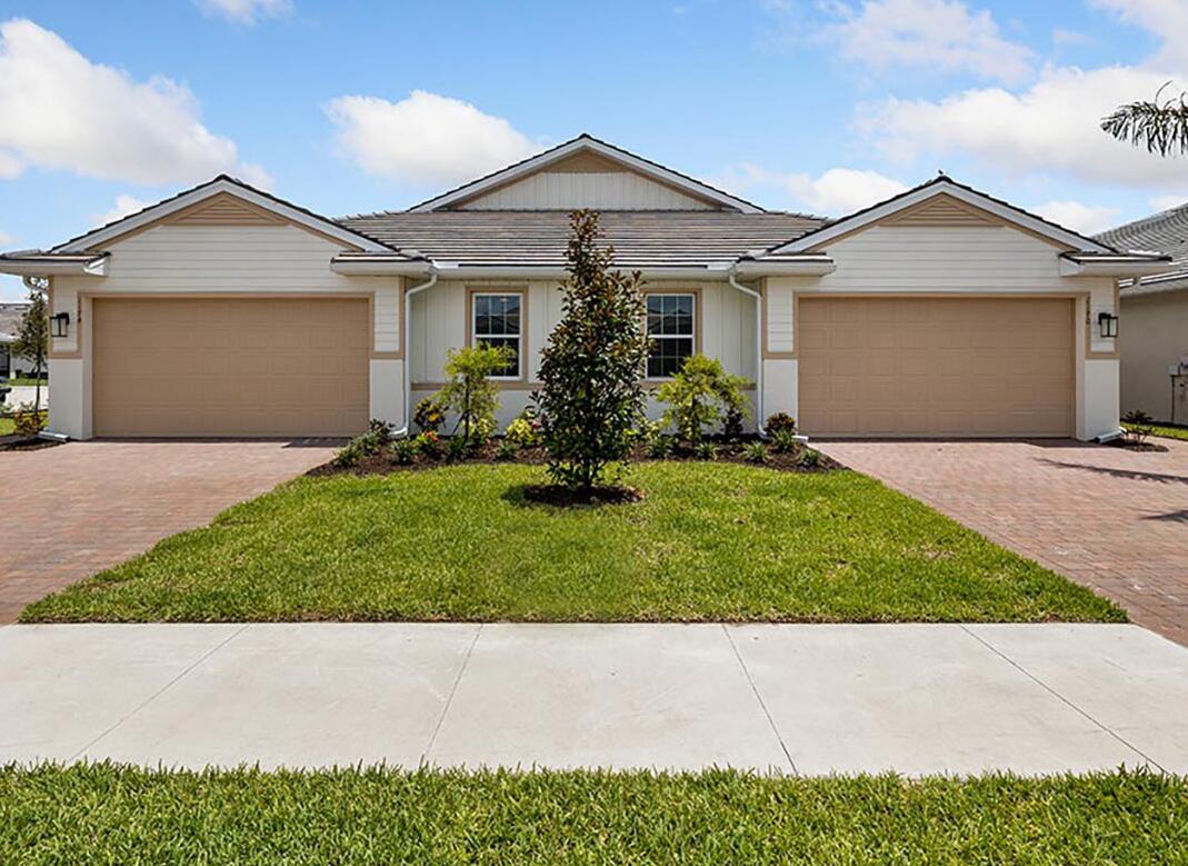1112 Enbrook Loop Naples, FL 34114 - Photo 1 of 1 front view of a house with a yard and trees