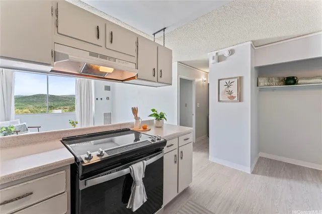 a kitchen with stainless steel appliances a stove a sink and a refrigerator