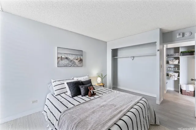 a bedroom with a bed and wall painting