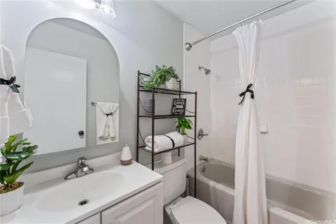 a bathroom with a granite countertop toilet sink and shower