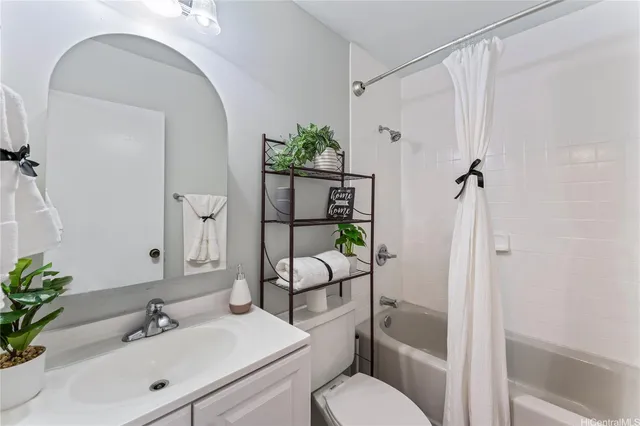 a bathroom with a granite countertop toilet sink and shower