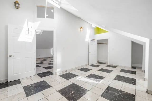 a kitchen with white cabinets and appliances