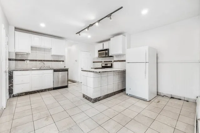 a view of a house with wooden deck