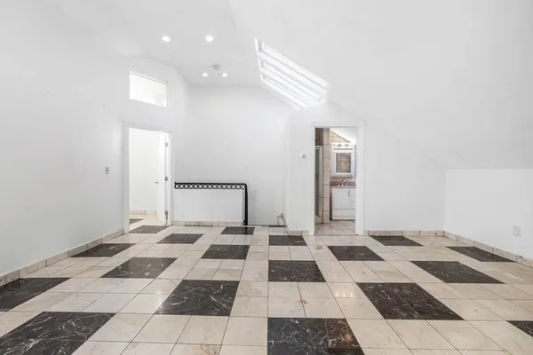 a spacious bedroom with a bed and a window