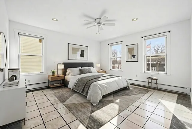 a view of a bedroom with wooden floor and bathroom
