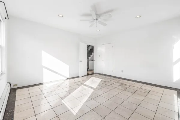 a view of an empty room and a window