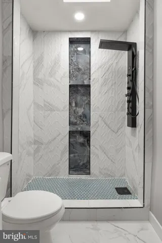 a bathroom with a toilet and a shower