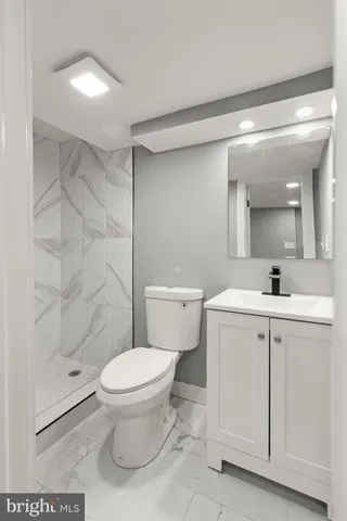 a bathroom with a toilet sink and a shower