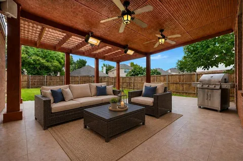 a view of a patio with couches chairs and a table with wooden floor