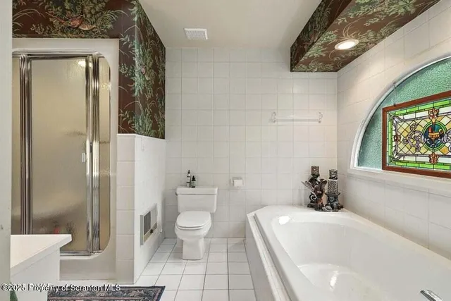 a bathroom with a toilet a sink and shower