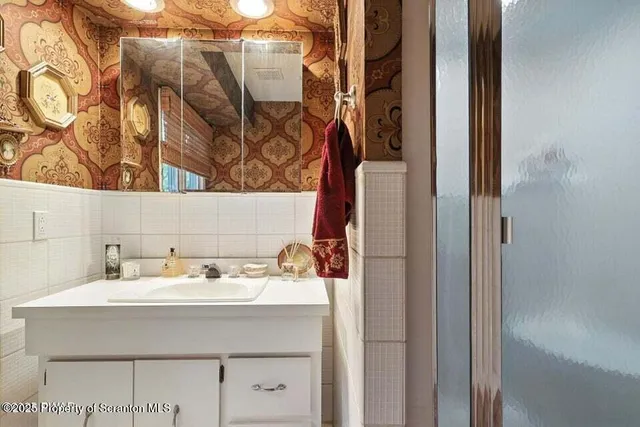a bathroom with a sink and a mirror