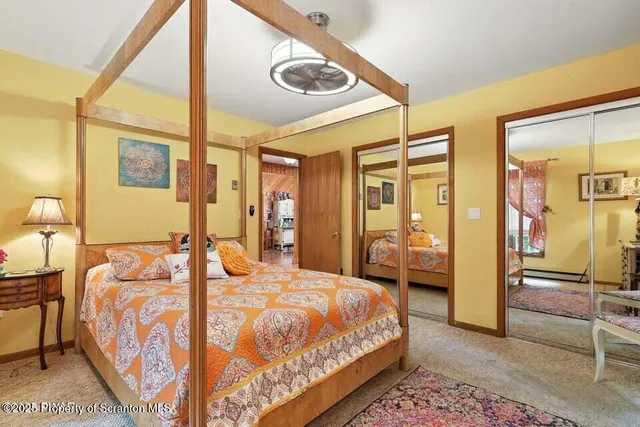 a bedroom with a large bed and a chandelier