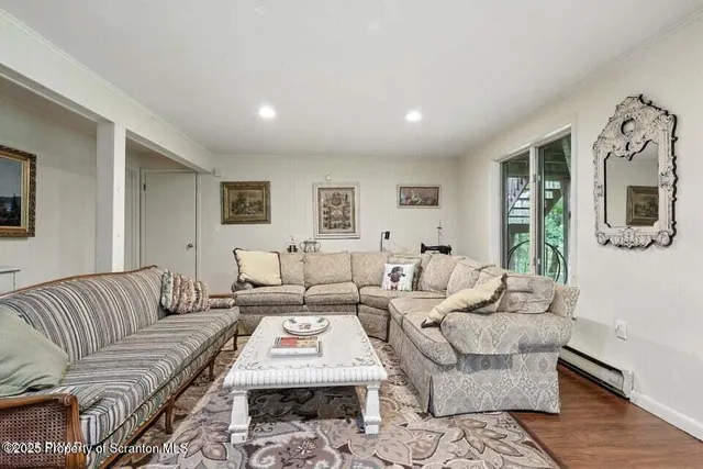 a living room with furniture fireplace and a window