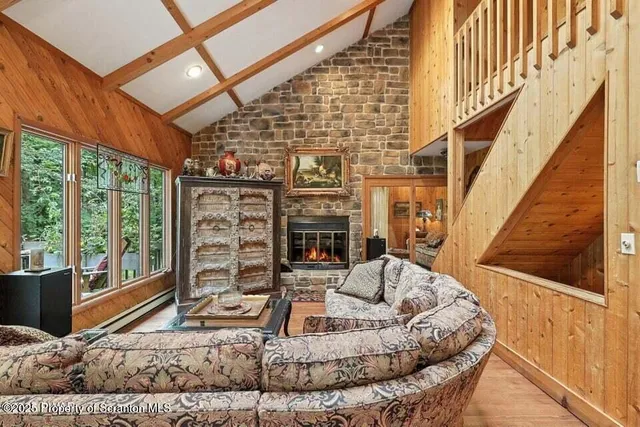 a living room with fireplace furniture and a floor to ceiling window