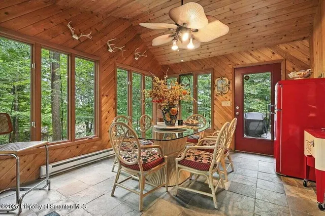 a view of a dining room with furniture large windows and wooden floor