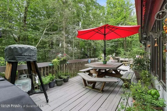 a view of a table and chairs under an umbrella