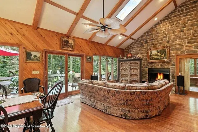 a living room with furniture a fireplace and a potted plant