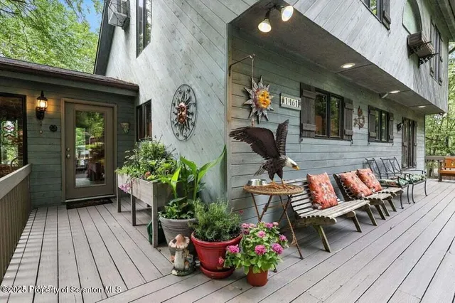 a view of balcony with wooden floor and outdoor seating