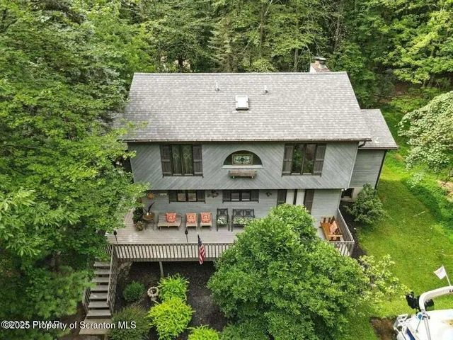 an aerial view of a house with a yard
