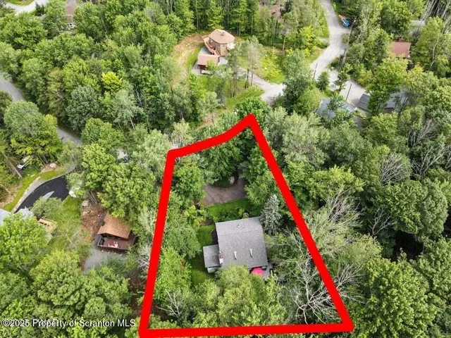 an aerial view of a house with a yard