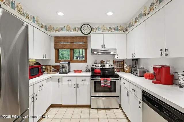 a kitchen with a sink cabinets and window