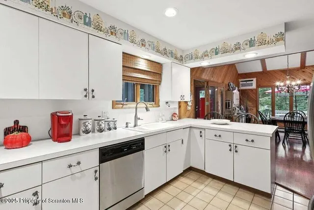 a kitchen with a sink cabinets and window