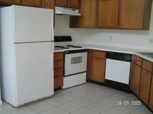 a kitchen with stainless steel appliances a refrigerator and a stove