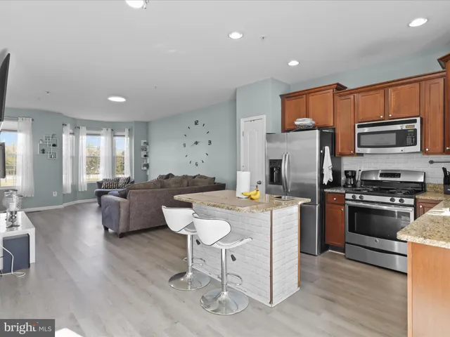 a kitchen with a sink a counter top space and stainless steel appliances