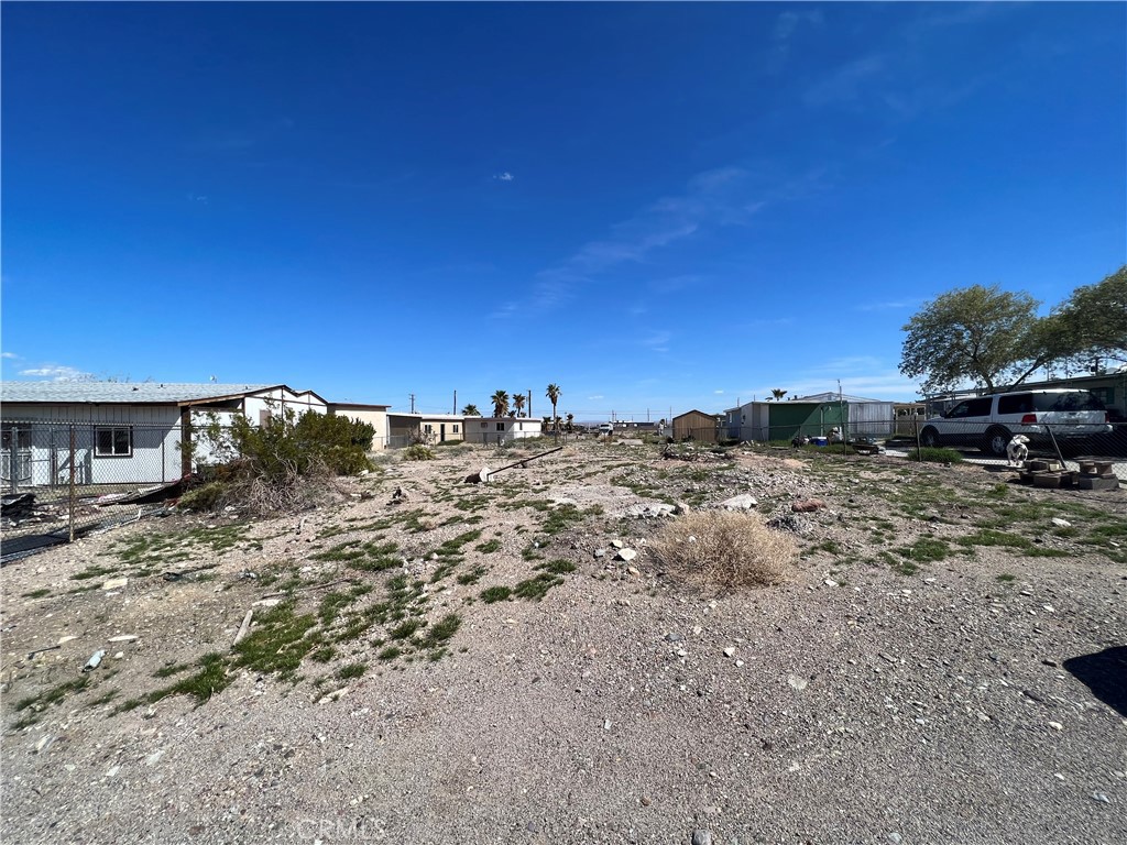 1205 Desert Drive Needles, CA 92363 - Photo 1 of 1 a view of a dry yard with trees