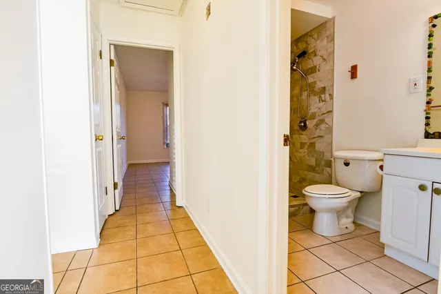 a bathroom with a toilet and a shower