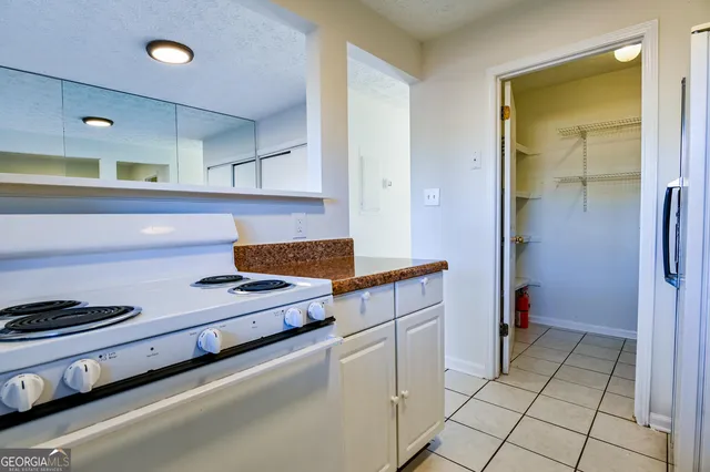 a kitchen with a stove and a refrigerator