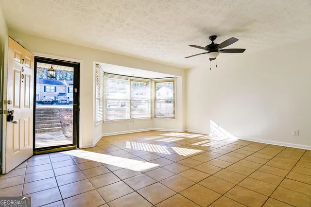 a view of a bedroom with a bed and a window