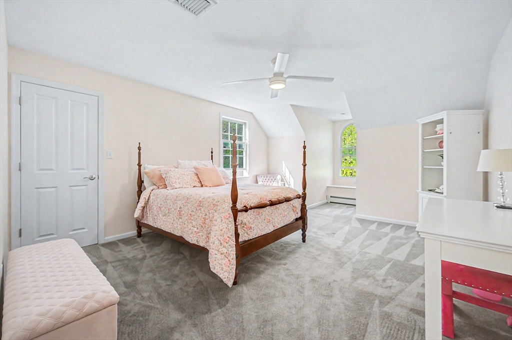 270 Mendon Road Sutton, MA 01590 - Photo 28 of 42 a bedroom with a bed and a chandelier