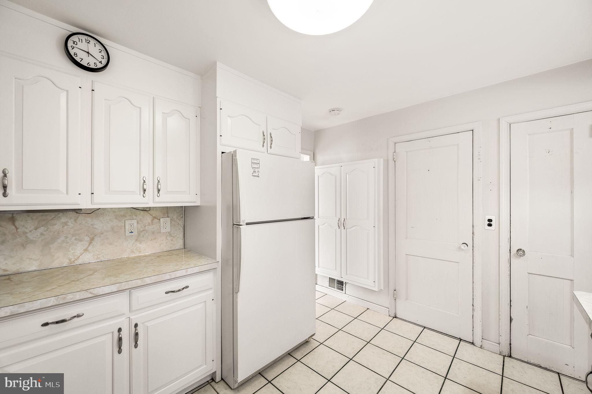 101 East Rose Valley Road Wallingford, PA 19086 - Photo 11 of 38 a kitchen with cabinets and a refrigerator