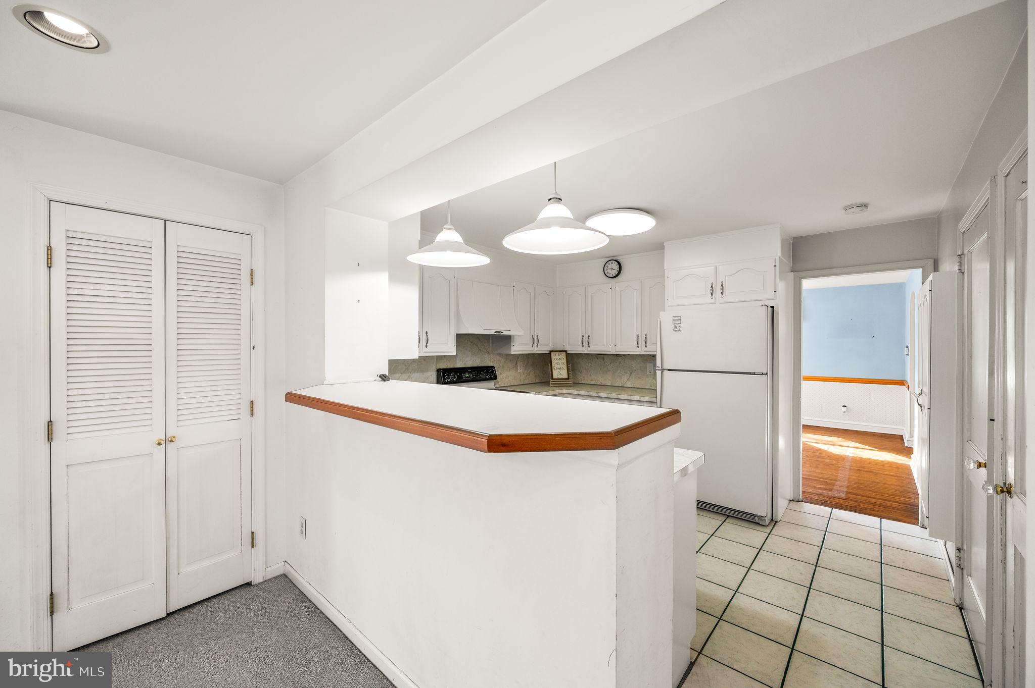 101 East Rose Valley Road Wallingford, PA 19086 - Photo 12 of 38 a kitchen with stainless steel appliances granite countertop a sink and a refrigerator