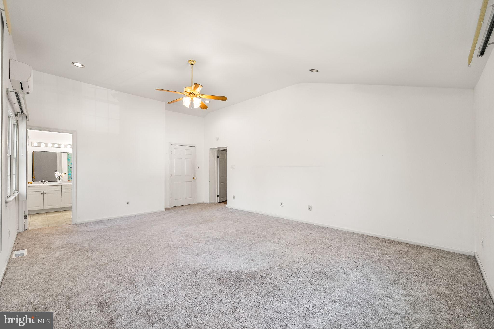 101 East Rose Valley Road Wallingford, PA 19086 - Photo 18 of 38 an empty room with a chandelier fan and windows