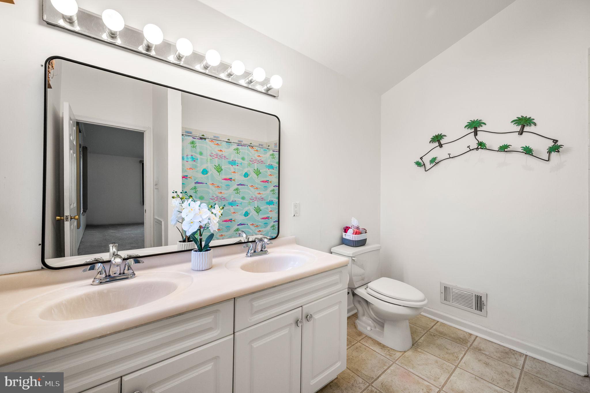 101 East Rose Valley Road Wallingford, PA 19086 - Photo 19 of 38 a bathroom with a sink vanity granite and toilet