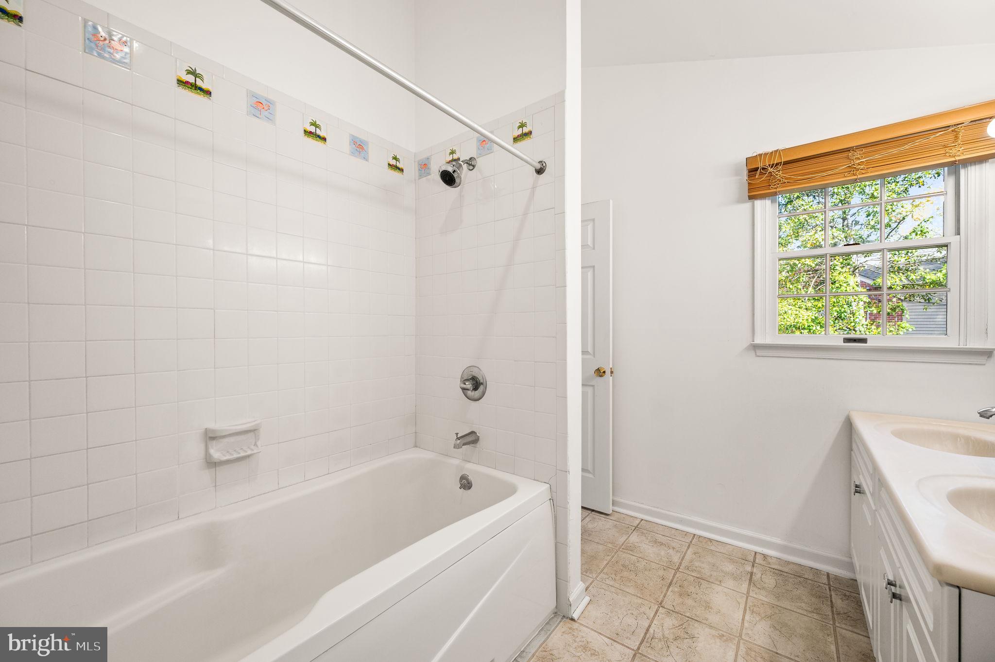 101 East Rose Valley Road Wallingford, PA 19086 - Photo 20 of 38 a bathroom with a bathtub a shower and a window