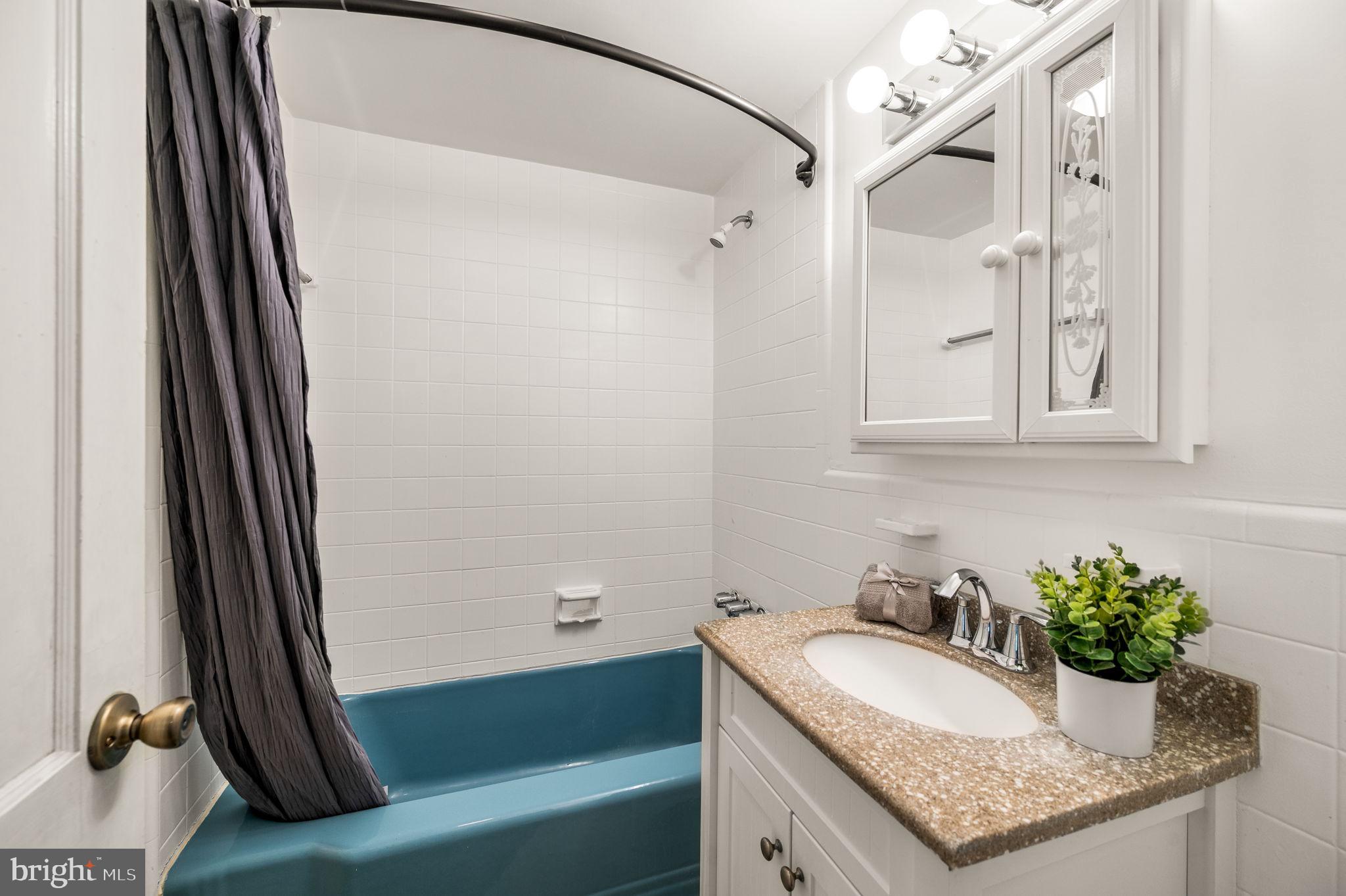 101 East Rose Valley Road Wallingford, PA 19086 - Photo 27 of 38 a bathroom with a granite countertop sink and a mirror