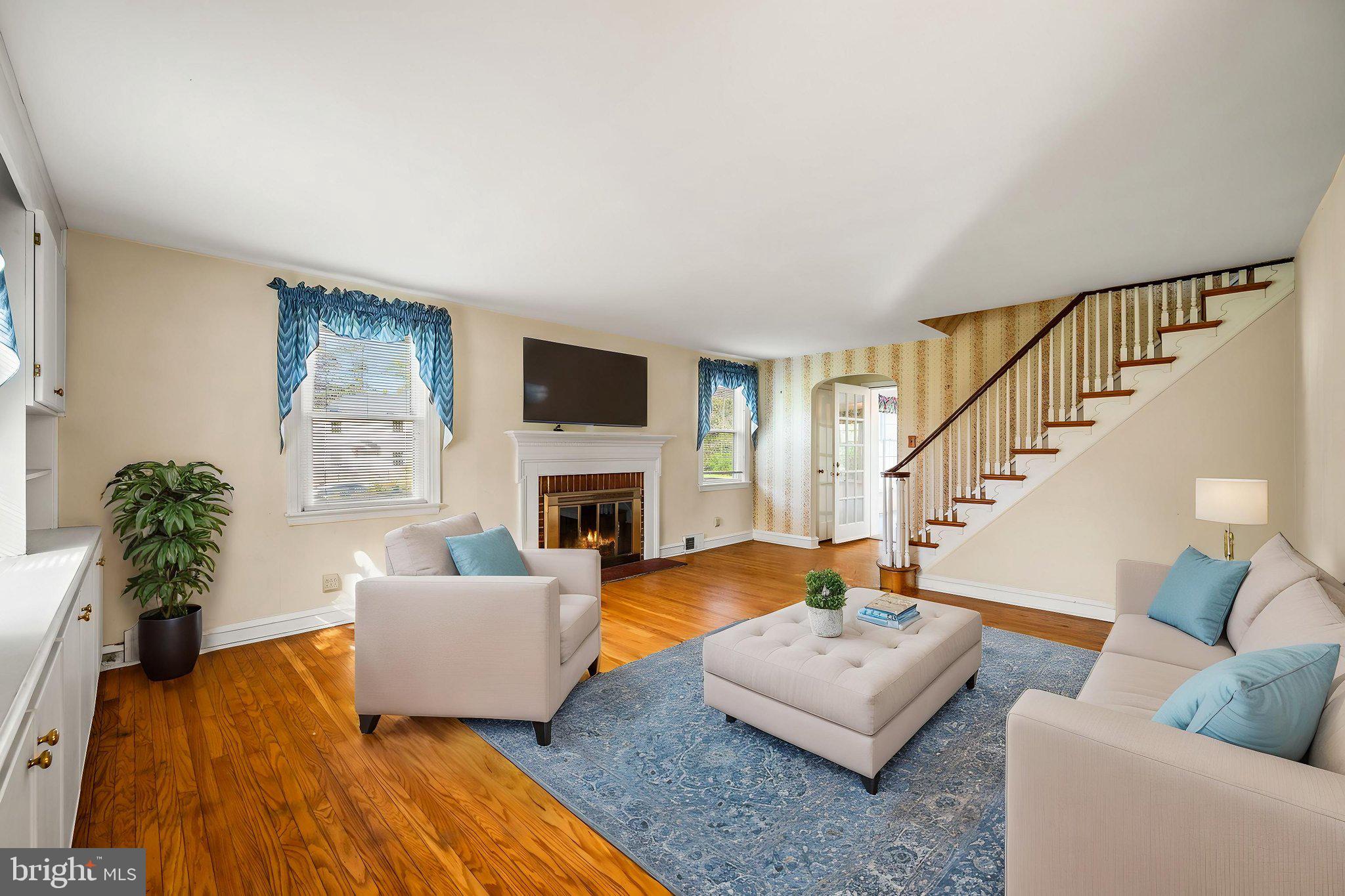 101 East Rose Valley Road Wallingford, PA 19086 - Photo 3 of 38 a living room with furniture and a fireplace